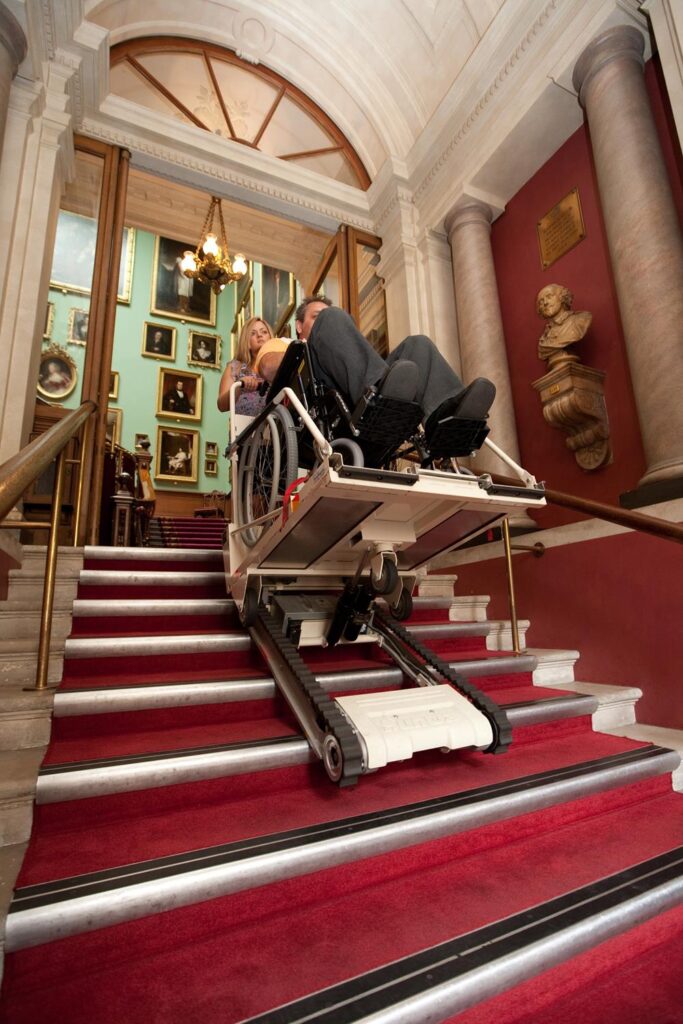 A woman using a stairmate major stairclimber to descend some stairs